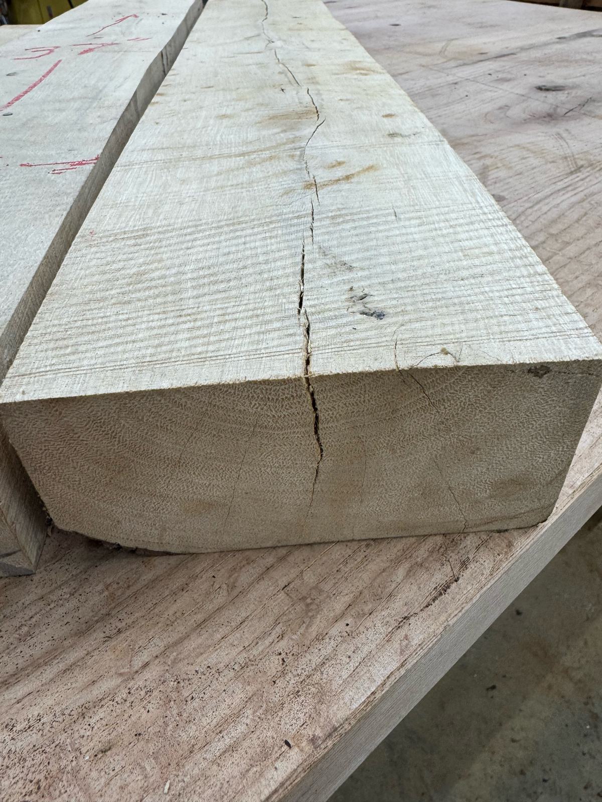 End grain and face of a GB001 gum bumelia board showing a check running along the face