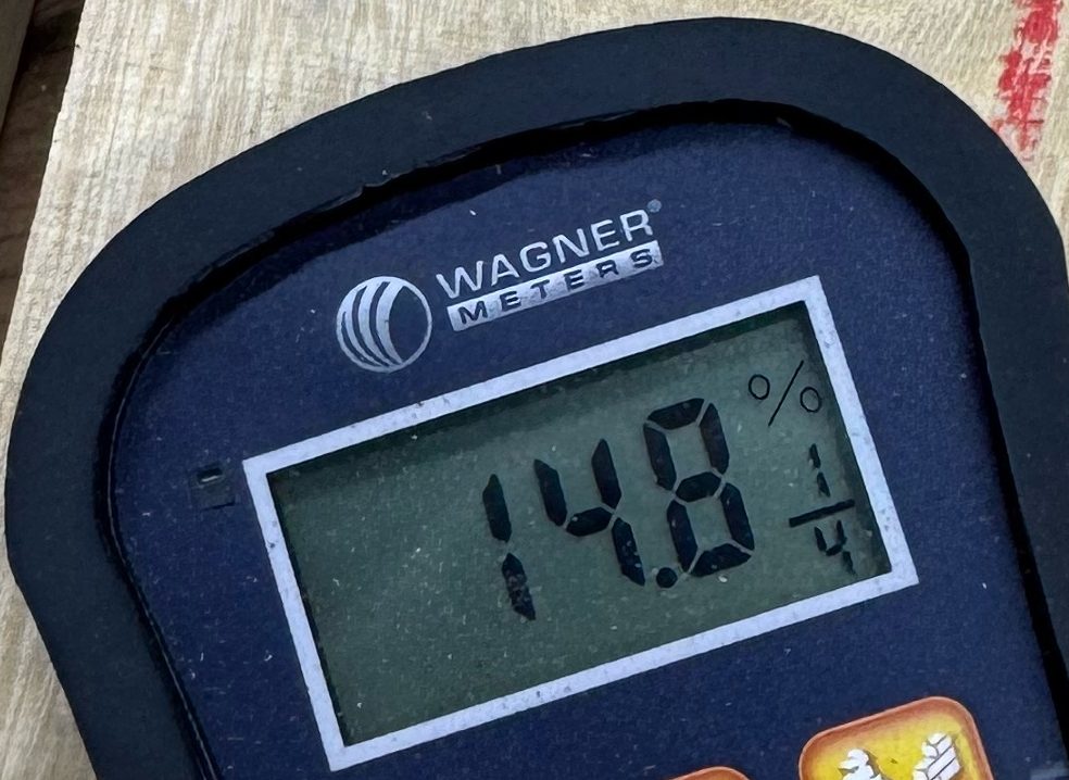 Wagner pinless moisture meter reading 14.8 percent on a GB001 gum bumelia board